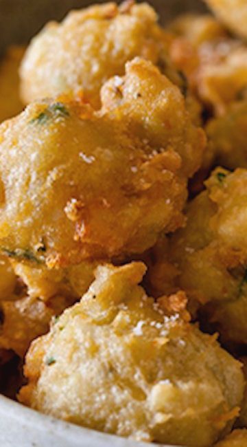 a white bowl filled with fried food on top of a table