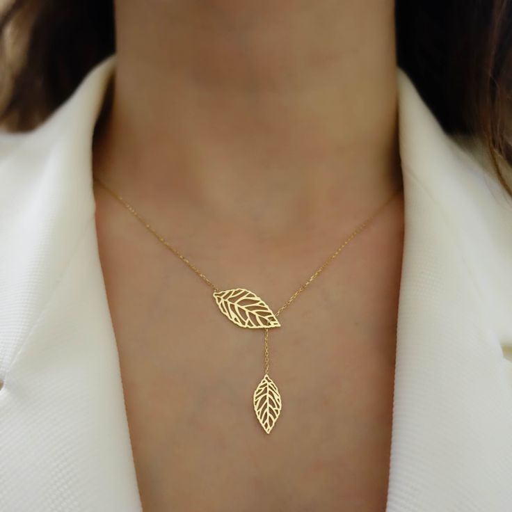 "\"Double Leaf Gold Necklace | Mother of Nature, Leaves of Tree Golden Pendant | Outline Hollow Leaves | Elegant Design | Gift for Her\" Perfect gift for your girlfriend, feyonce, wife, mother, daughter and for you best friend It can be gifted in anniversary, birthday, graduation, baby shower, and similar occasions. * Material: 14k Yellow Gold, 14k Rose Gold, 14k White Gold * Leaf Size (On Top): 0,87\" x 0,43\" // 22mm x 11mm (±5%) * Necklace Length: 14\" - 20\" // 35,6cm - 50,8cm (Please contac Yellow Gold Leaf Shape Nature-inspired Jewelry, Yellow Gold Leaf Necklace As Gift, Yellow Gold Leaf Necklace For Gift, Gold Plated Lariat Jewelry For Wedding, Handmade Yellow Gold Lariat Jewelry, Minimalist Yellow Gold Leaf Jewelry, Yellow Gold Leaf-shaped Jewelry Gift, Elegant Rose Gold Leaf Jewelry, 14k Rose Gold Necklaces For Jewelry Making