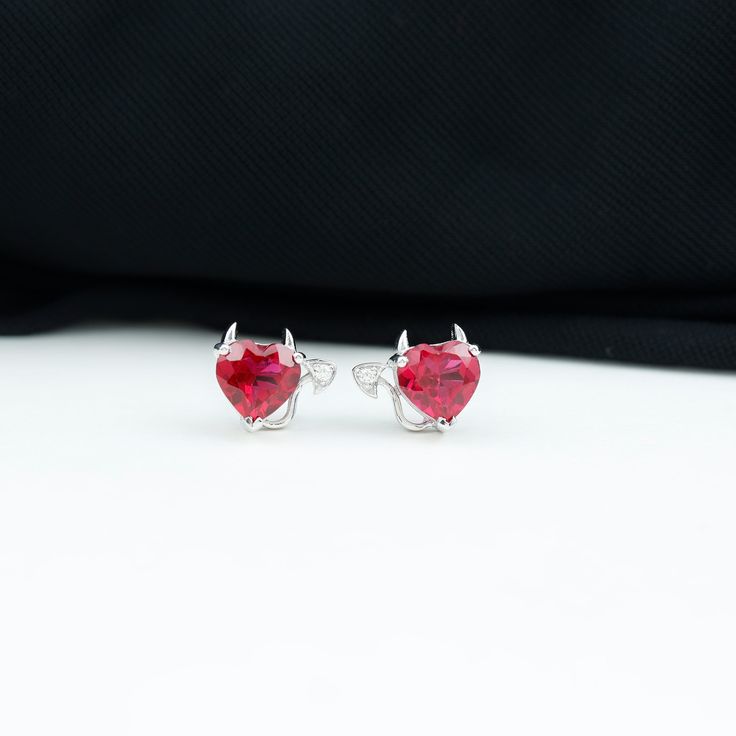 Product Details Elevate your style with our captivating Gothic Stud Earrings, a bold and enchanting accessory that commands attention and leaves a lasting impression. These striking Solitaire Stud Earrings showcase a stunning Heart Shape Lab Grown Ruby gemstone, meticulously set in secure Prong Setting, while the intricate tail is adorned with sparkling Moissanite gemstones. These Heart Stud Earrings are more than just earrings; they are a unique fashion statement that embodies both elegance and Sterling Silver Jewelry With Prong Setting For Valentine's Day, Red Prong Set Earrings For Valentine's Day, Red Prong-set Earrings For Valentine's Day, Valentine's Day Red Earrings With Prong Setting, Heart-shaped Sterling Silver Earrings With Prong Setting, Fine Jewelry With Matching Earrings For Valentine's Day, Valentine's Day Heart Cut Earrings With Prong Setting, Valentine's Day Double Heart Jewelry For Pierced Ears, Valentine's Day Fine Jewelry With Matching Earrings