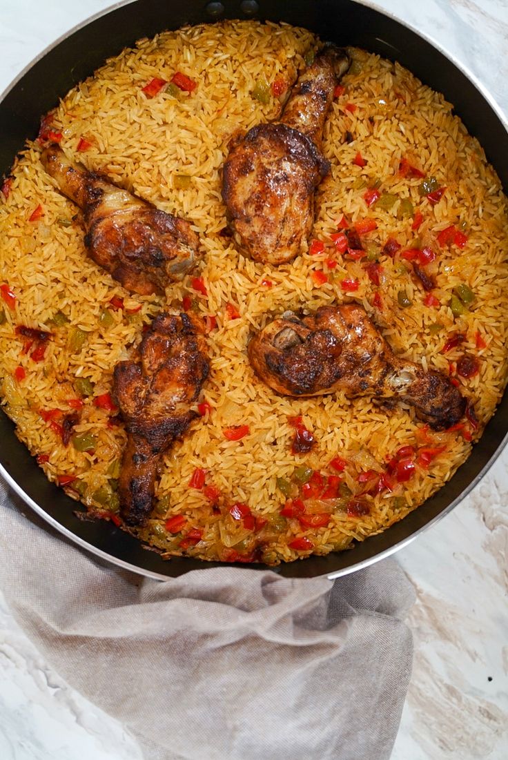 a pan filled with rice and meat on top of a table