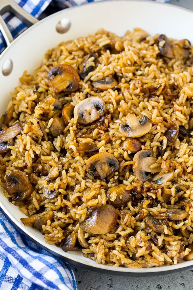 mushroom rice in a white bowl on a blue and white checkered table cloth