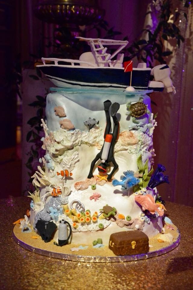 there is a cake that looks like a boat in the ocean