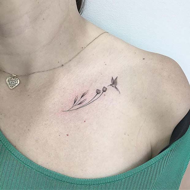 a woman's chest with a small flower tattoo on her left side ribcage