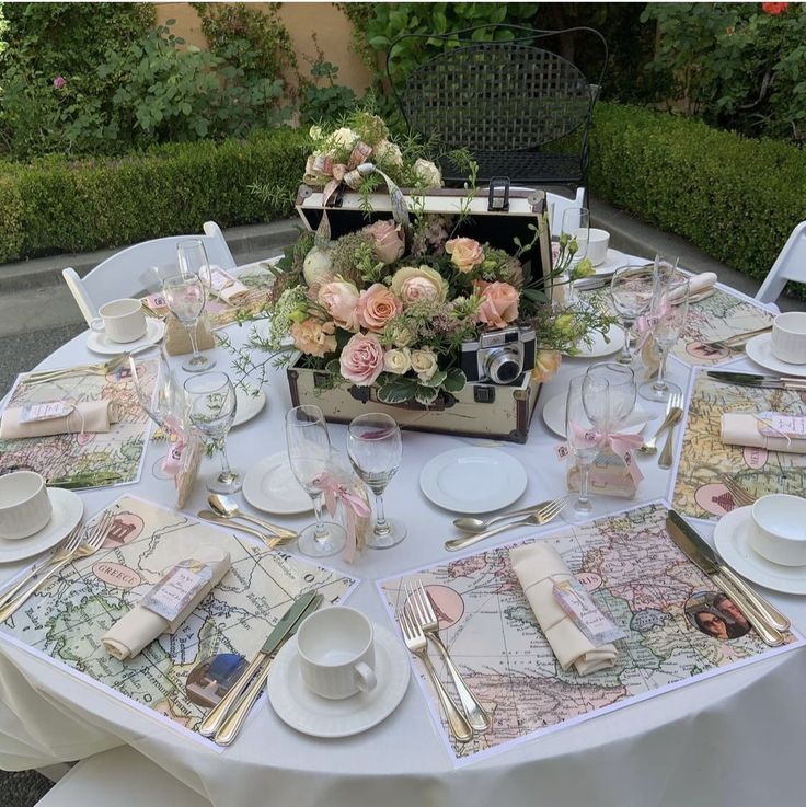 a table set with place settings and flowers