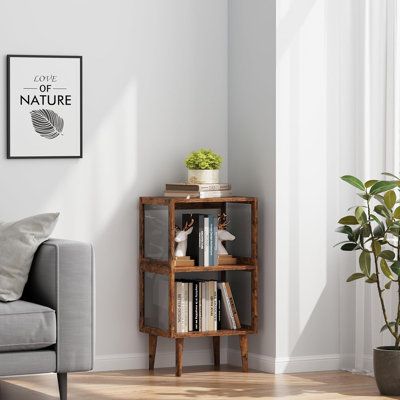 a living room with a couch, book shelf and potted plant