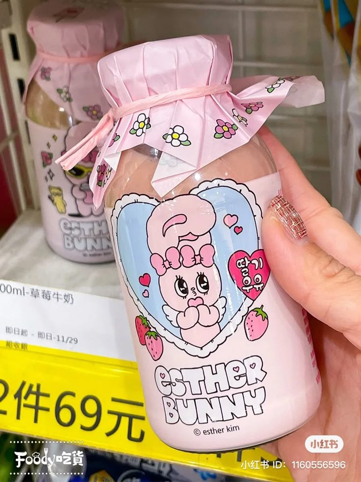 a person holding up a plastic bottle with an animal on it's side in a store