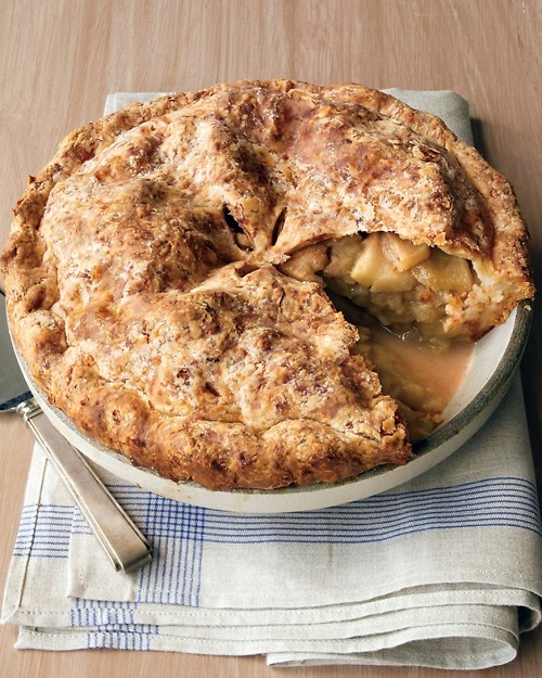 a pie on a plate with a knife and fork