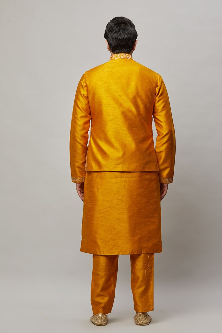 Raw Silk Kurta with intertwined sequence and thread work on the vest plus matching pants. Crafted with a collar neckline, full sleeves, and front button closure. Occasion: Can be worn to events like Sangeet, Mehendi, & Wedding WASH CARE INSTRUCTIONS - Please Dry clean only when it is applicable. Slight color variation is possible due to digital photography. Formal Festive Long Sleeve Pant Set, Fitted Long Sleeve Pant Set For Festivals, Festive Fitted Sets With Stand Collar, Fitted Kurta With Set-in Sleeves For Festive Occasions, Fitted Long Sleeve Pant Set For Diwali, Fitted Zari Work Set With Stand Collar, Festive Fitted Kurta With Set-in Sleeves, Yellow Sherwani With Cutdana In Straight Kurta Style, Multicolor Embroidered Resham Bandhgala Straight Kurta