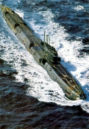 an aerial view of a submarine floating in the ocean with water around it and waves surrounding it