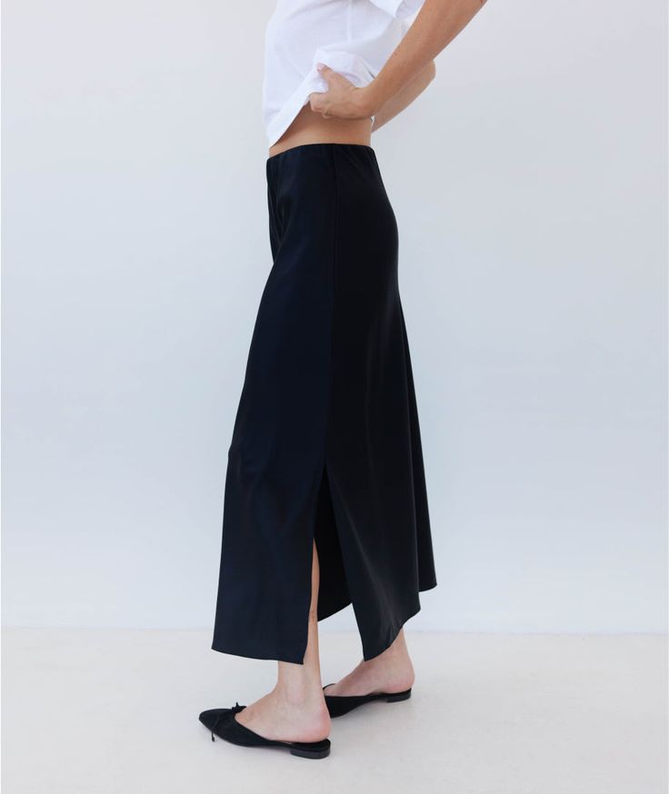 We continue to perfect our slip skirt. Once you slip on this insanely luxe silky charmeuse skirt, you'll realize that it's the sexiest companion you've ever seen to every tank top, knit top, sweater, blouse and button down you own (truly–this pairs with everything, it's like magic). It works with heels, sandals, loafers and even sneakers. It's possible that you may go through a phase where you wear nothing else. HERE FOR IT. Relaxed Satin Skirt For Fall, Fitted Bias Cut Maxi Skirt For Summer, Chic Fitted Maxi Skirt For Daywear, Spring Stretch Maxi Skirt For Night Out, Chic Silk Bottoms With Bias Cut, Silk Long Skirt For Fall, Chic Stretch Maxi Skirt For Day Out, Chic Satin Skirt For Fall, Chic Silk Bias Cut Bottoms