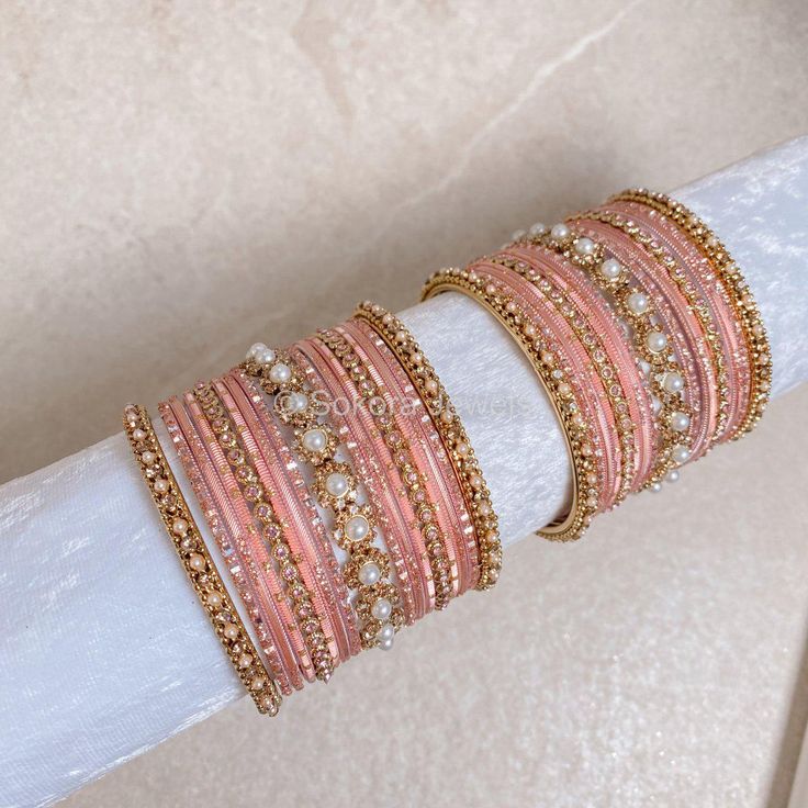 2 Small stacks of Antique Gold bangles with Pearl and gold stonework details finished with pretty pinks and our favourite Daisy Bangle in the centre to add that sparkle. Ready to Ship! Packed in small box ( no roll ) Stackable Rose Gold Bangle For Wedding, Rose Gold Stackable Bangle For Wedding, Pink Stackable Jewelry For Festive Occasions, Festive Pink Stackable Jewelry, Pink Stackable Beaded Bracelets For Party, Pink Beaded Bangle Bracelets For Wedding, Festive Pink Stackable Bracelets, Pink Stackable Bangle As Gift, Elegant Pink Beaded Bracelets For Festive Occasions