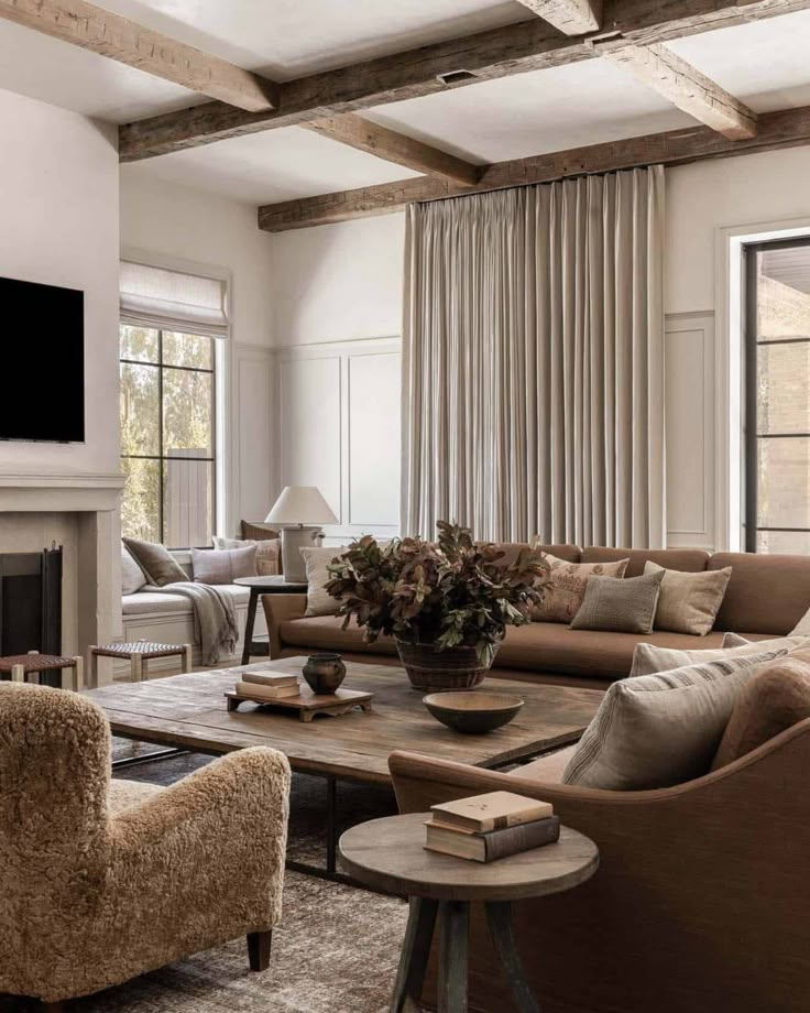 a living room filled with furniture and a flat screen tv mounted on the wall above a fireplace