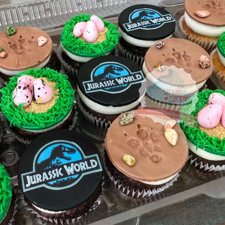 cupcakes decorated with animals and grass in the shape of farm animals are on display