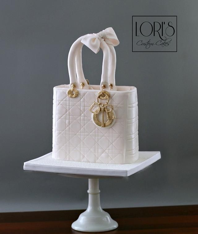 a white purse cake with a bow on top