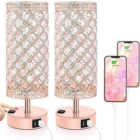 a pink table lamp next to two cell phones