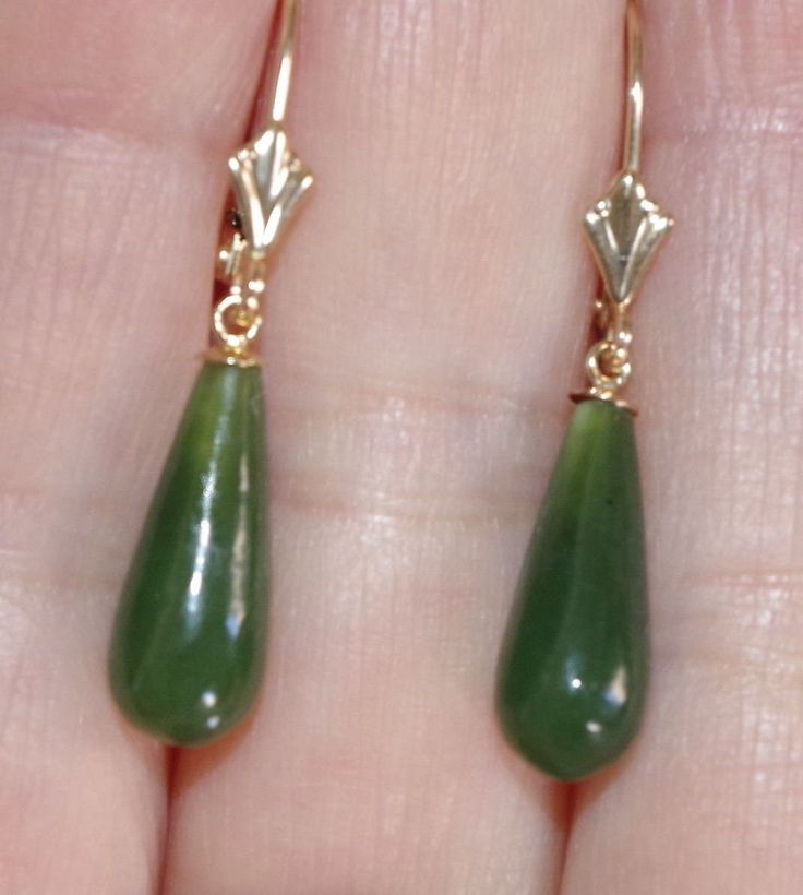 Vintage gorgeous genuine 14k green jade jadeite tear drop lever back earring vintage adorable pair of 14k gold hand carved 33 mm jade lever back earrings length of drops 33 mm diameter of jade 6mm at widest part noticeable size stylish / 2.4 grams / 12 carats vintage old stock jades every pair is a bit different based on the nature of jade. gorgeous coloring on these carved green jades very cool looking. you will love wearing it. October Jewelry, Jade Earrings, Gold Hand, Jewelry Lookbook, Leverback Earrings, Jade Jewelry, Green Earrings, Fantasy Jewelry, Green Jade