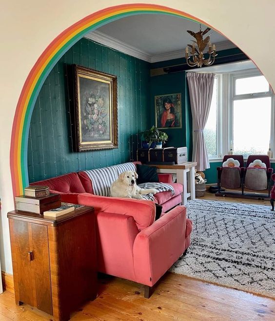 a living room filled with furniture and a rainbow colored arch in the middle of it