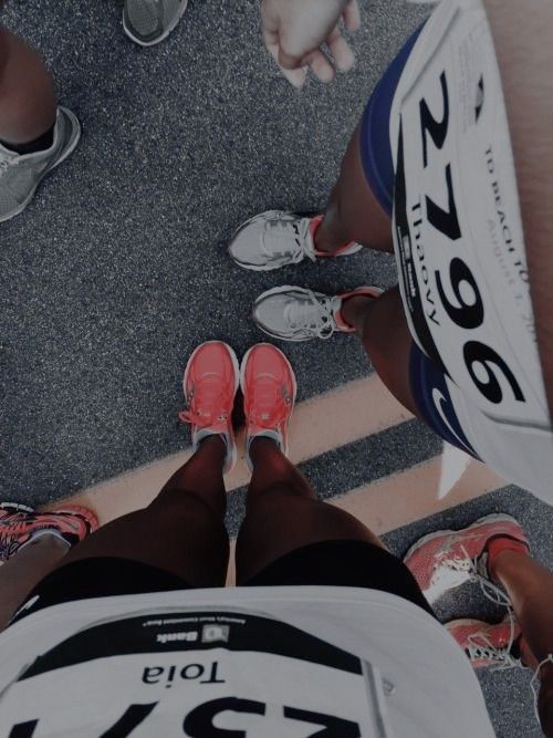 two people standing next to each other with their feet on the ground and wearing running shoes