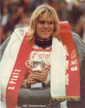 a woman with a scarf around her neck holding a trophy