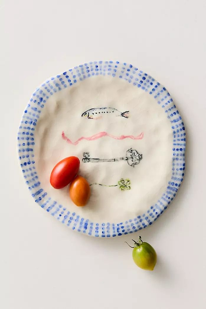 a paper plate with some tomatoes and other vegetables on it, sitting next to each other