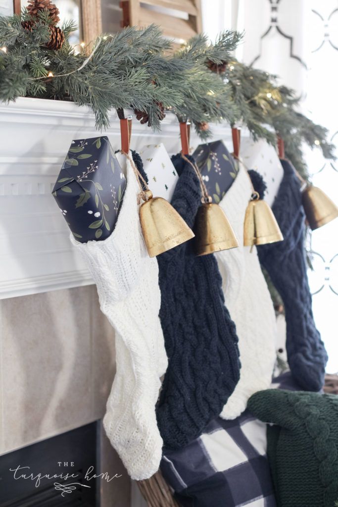 stockings hanging from a mantel with bells on them