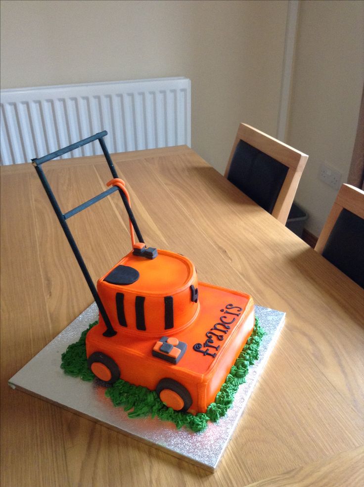 a cake shaped like a lawn mower sitting on top of a table