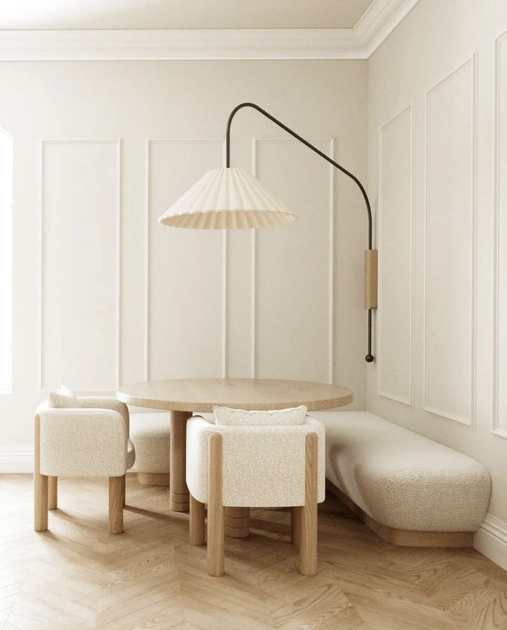 a dining room with white walls and wood flooring, an umbrella lamp over the table