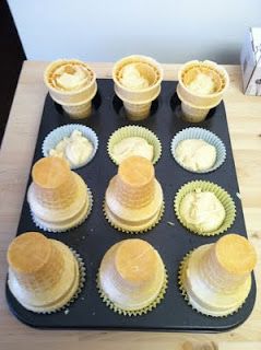 cupcakes with frosting in paper cups on a tray