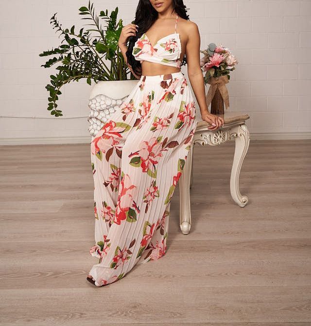 This beautiful flowy 2 piece includes 1 white floral print pleated halter top with self tie in the back. Pants is a wide pleated white with floral print and hidden zipper at back. Material: Self: 100% Polyester Lining: 100% Polyester Neckline: V Neckline Sleeve Style: Sleeveless Closure Style: Pullover Garment Length: Top is Crop Top Length and Pants is Full Length White Summer Set For Brunch, Chic Chiffon Sets For Spring, White Two-piece Summer Set, Summer White Two-piece Set, White Two-piece Set For Spring, Spring Two-piece White Set, White Floral Print Sets For Spring, Spring White Floral Print Sets, Spring Season White Floral Print Sets