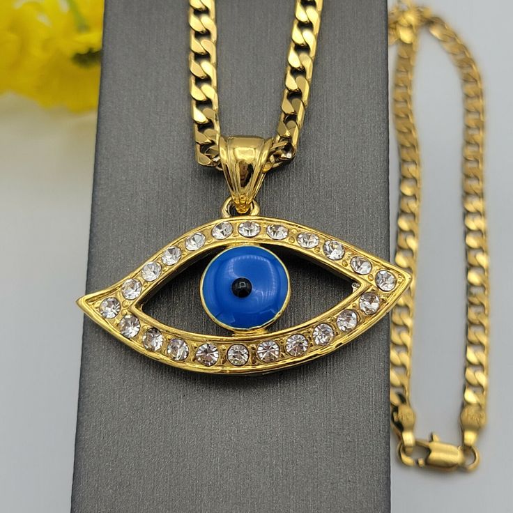 GOLD PLATED JEWELRY Blue Evil Eye Protection Necklace. 24K Gold Plated The evil eye is commonly used as an amulet or talisman in order to cleanse curses away. It is a common belief in most cultures. If you wear the evil eye figure in talismans, symbols and jewelry, you’re supposedly shielding yourself from greater doom. PENDANT Material: 24K Gold Plated over environmental copper Size: 1.75" W x 1.25" H (Including Bail) *Size Reference: A Quarter Coin is 0.95in / almost 1 inch* CHAIN Material: 24K Gold Plated over environmental copper Size: 18 inches - 4mm We seek to do the best in our work, if there is any problem, please let us know to fix it ASAP. God bless you! U.S. Seller:  Shipping with tracking number. Blue Metal Charm Necklace With Adjustable Chain, Blue Metal Necklace With Charms, Blue Metal Charm Necklace With Round Pendant, Blue Pendant Necklace With Adjustable Chain, Blue Metal Necklace With Round Pendant, Blue Round Pendant Metal Necklace, Blue Metal Round Pendant Necklace, Blue Metal Necklace With Evil Eye, Blue Pendant Charm Necklace With Adjustable Chain