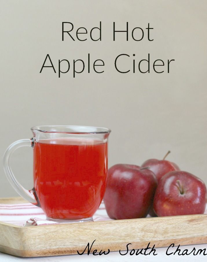 red hot apple cider with two apples on the side