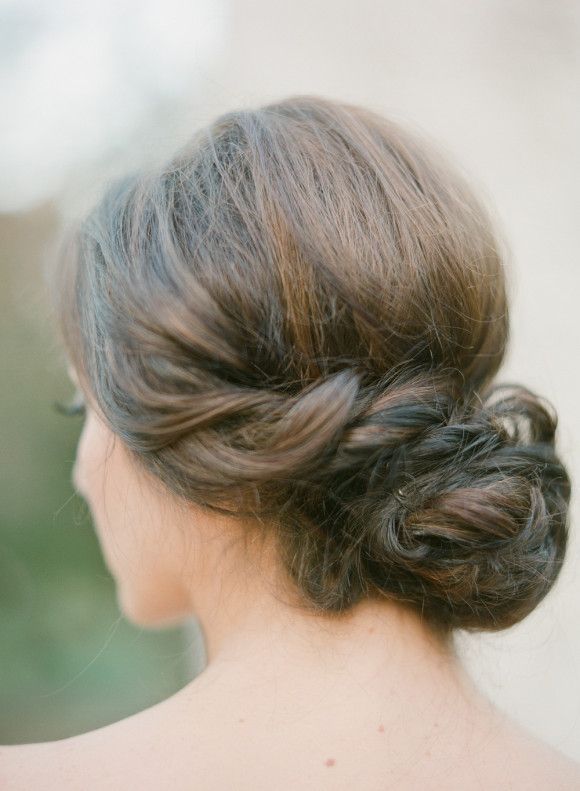 a woman with her hair in a low bun