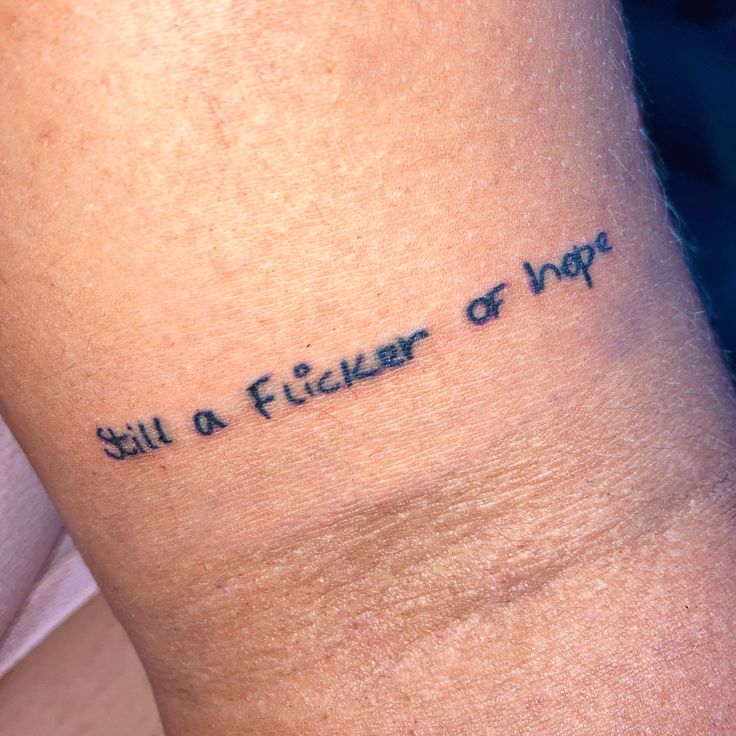 a woman's arm with the words still a fighter of hope written on it