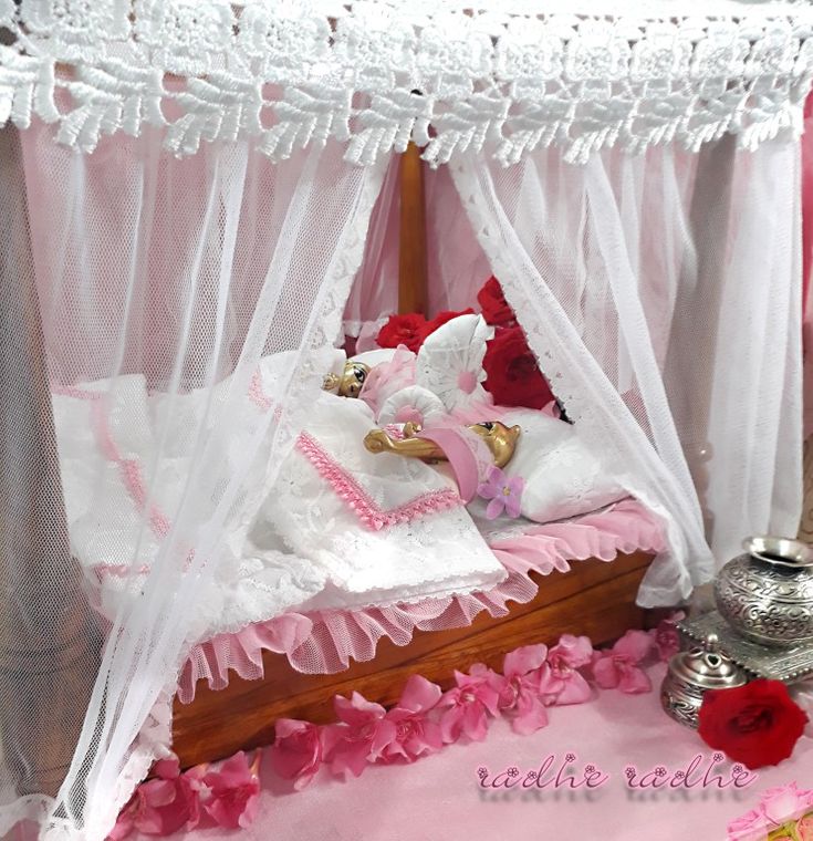 there is a bed with pink and white decor on it