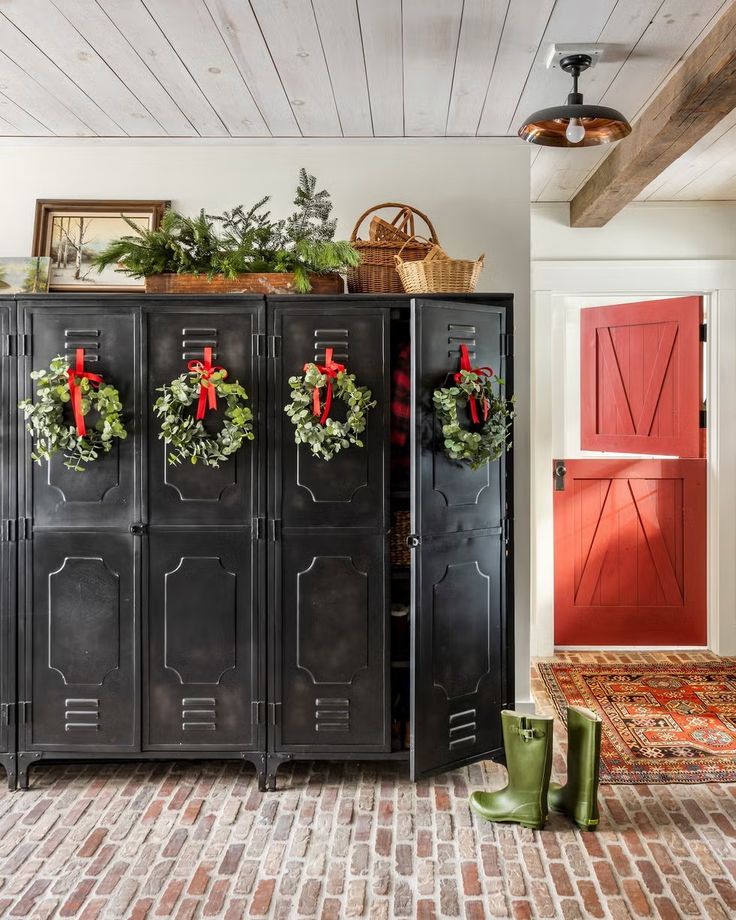 a black cabinet with wreaths on the doors