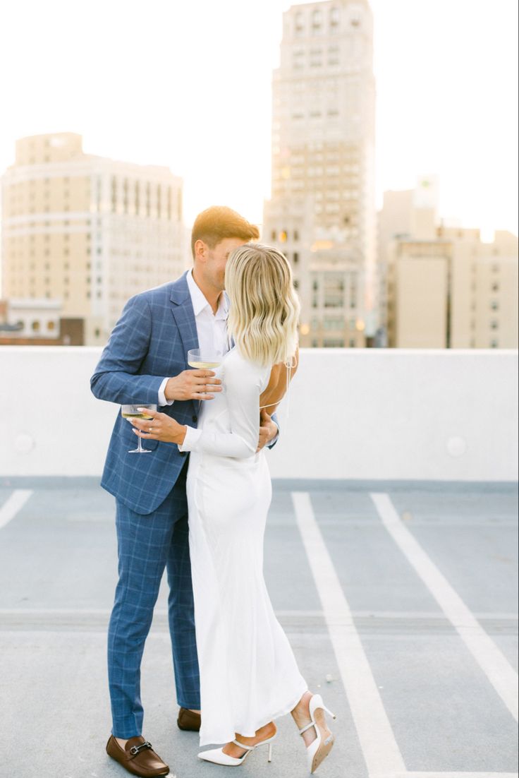 couple engagement shoot champagne golden hour sunset White Blazer Engagement Photos, Fancy Engagement Photos Outfits, Engagement Photos White Backdrop, Mens Engagement Shoot Outfit, Engagement Photos Outfits Elegant, Engagement Photos Fancy Outfits, Modern Classic Engagement Photos, Elegant Engagement Photos Outfits, Engagement Photo Men Outfit