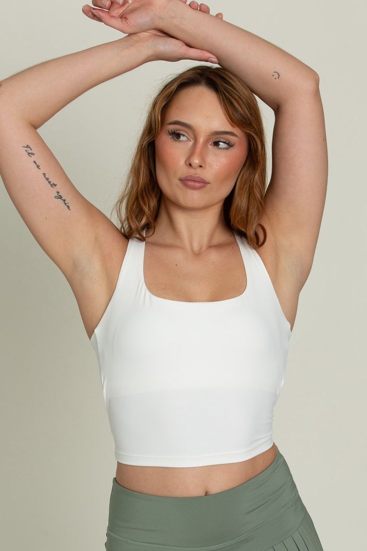 Our Whiteout Criss Cross Back Yoga Tank is our newest athletic tank and it is so flattering! It has a U-shaped front that offers coverage and a cute criss-cross style back. It features our ultra smooth, sweat-wicking material that you can wear when active or just out for the day! It is complete with built-in padding that can be removed if needed. Cross Back Activewear With Built-in Bra And High Stretch, Yoga Cross Back Tank Top, Bra Friendly, Compressive Cross-back Sports Bra For Yoga, Yoga T-back Tank Top With Built-in Bra, Compressive Cross-back Yoga Top, Flare Yoga Pants, Yoga Tank, Tennis Skirts, Athletic Top