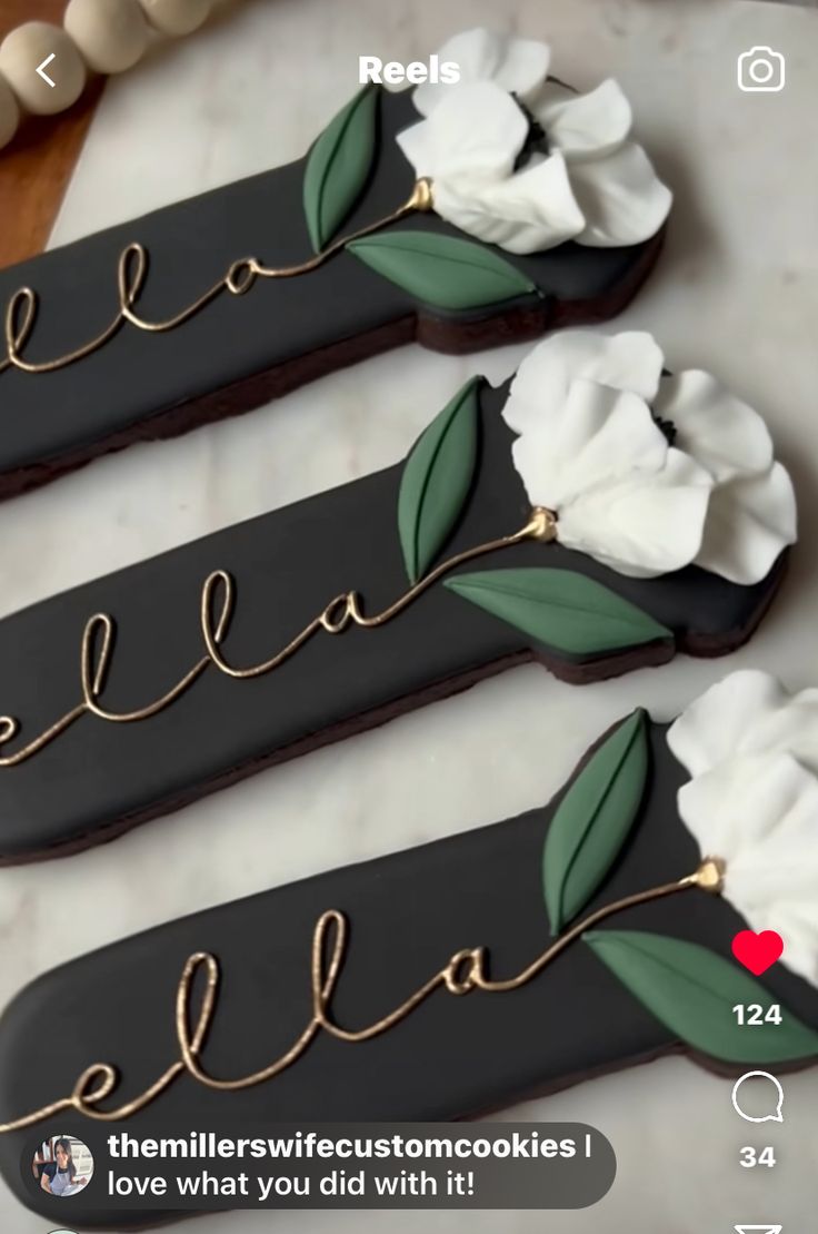 three cookies decorated with flowers and the words stella on them