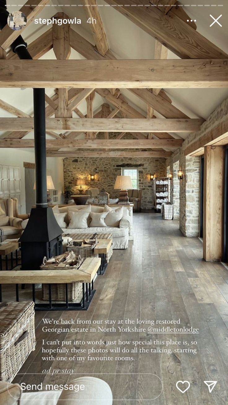 a living room filled with furniture and a wood burning stove in the middle of it