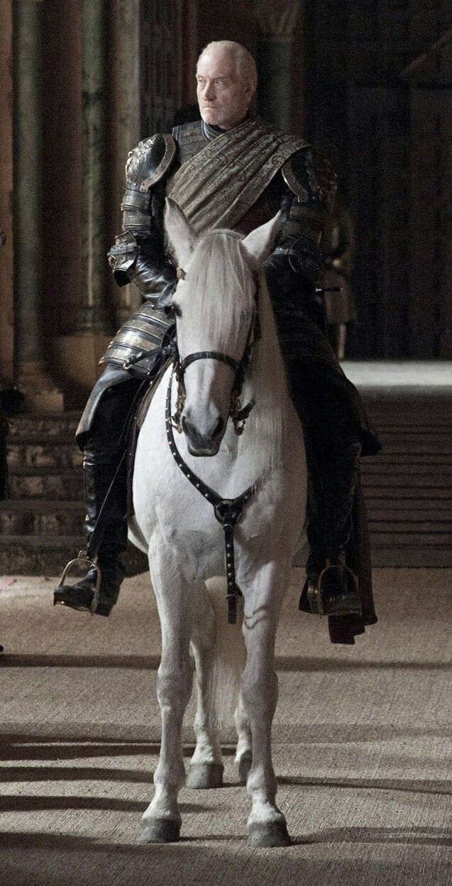 a man in armor riding on the back of a white horse through a palace like setting