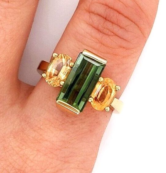 14 k Yellow Gold, Tourmaline and Citrine Ring Size 7 1/2 The Green Tourmaline is an Emerald Cut with a Beautiful Color. It is approx. 13 x 6 mm  and 5.50 carats The Peach Colored Citrines are oval shape and approx. 7 x 5 mm / 0.85 carats each for a total of approx. 1.70 carats.  Ring is Stamped : 14K Weight:  6.6 grams Beautiful Ring! Please shop with care. 15%  restocking fee Another Piece of Beautiful Jewelry From Gold and Silver Jewelry Exchange Please look at pictures carefully.  Item pictur Gold And Silver Jewelry, Citrine Ring, Beautiful Ring, Green Tourmaline, Ring Size 7, Emerald Cut, Gold And Silver, Oval Shape, Beautiful Rings