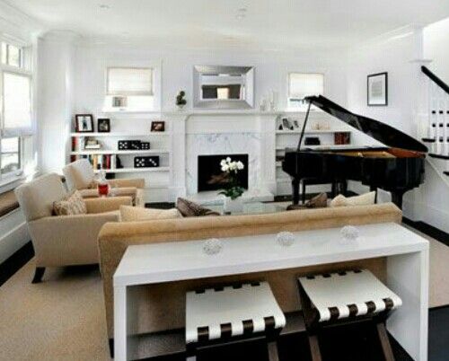 a living room filled with furniture and a piano