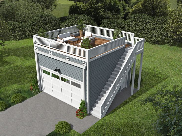 an aerial view of a garage with stairs leading up to the second floor and balcony