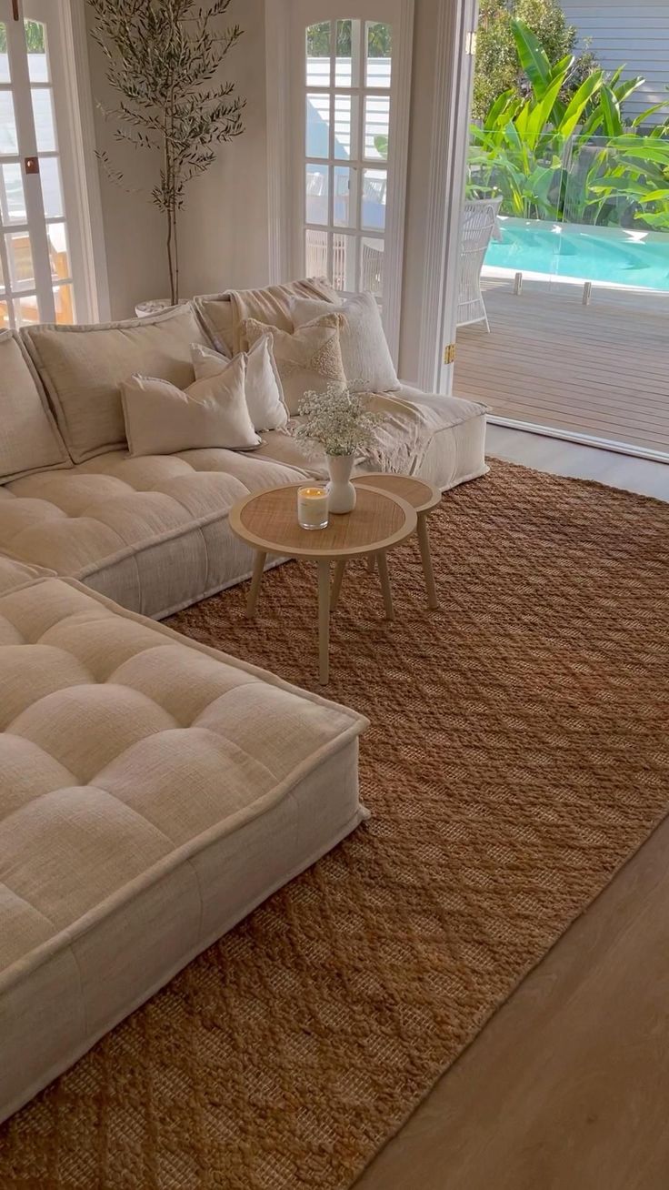 a living room filled with furniture and windows