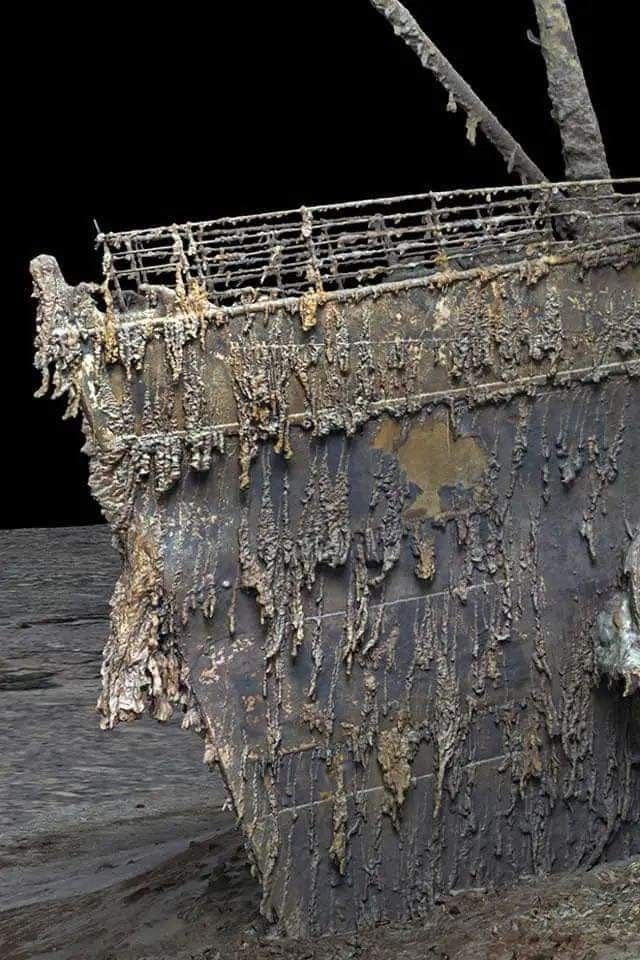 an old rusted ship sitting on top of the ocean