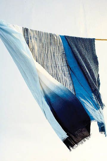 a blue and white cloth hanging from a clothes line