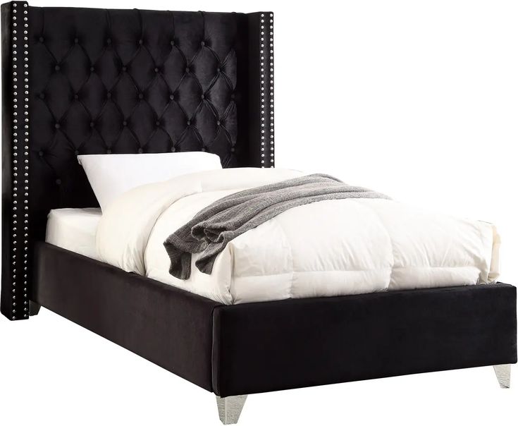 a bed with black headboard and foot board on it's side, in front of a white background