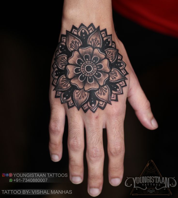 a woman's hand with a tattoo design on it