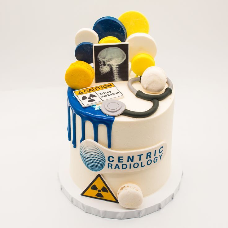 a white cake with yellow and blue decorations