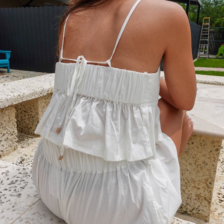 The Alaia Set is a perfect blend of elegance and versatility, designed for effortless summer style. Featuring a pleated cami and matching high-waisted shorts, this coordinated look offers both comfort and sophistication for any occasion. Chic Beach Tops With Strappy Back, Chic Strappy Back Tops For Beach, Summer Chic Tops With Strappy Back, Summer Backless Tops With Delicate Straps, Backless Top With Adjustable Straps For Vacation, Chic Strappy Back Beach Tops, Chic Top With Adjustable Straps And Strappy Back, Chic Tops With Adjustable Straps And Strappy Back, Casual Backless Tops With Adjustable Straps